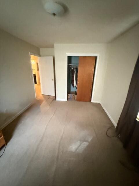 unfurnished bedroom with a closet and carpet flooring