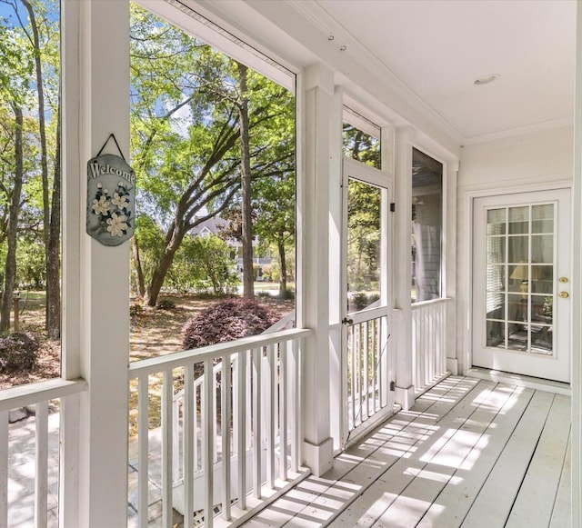 unfurnished sunroom with crown molding