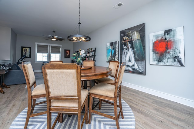 dining area with hardwood / wood-style flooring and a chandelier