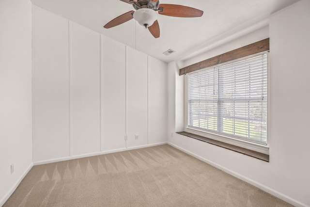 carpeted spare room featuring ceiling fan