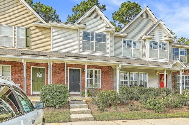 townhome / multi-family property featuring a porch