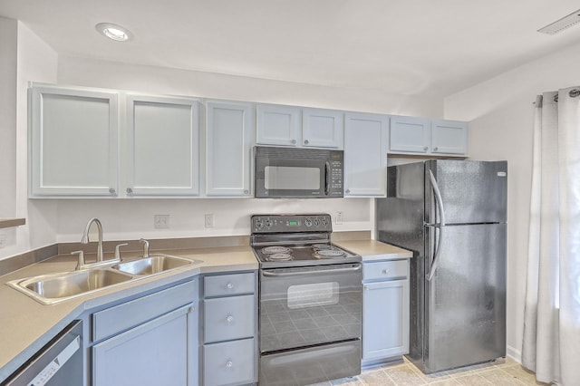 kitchen featuring light tile patterned flooring, sink, and black appliances