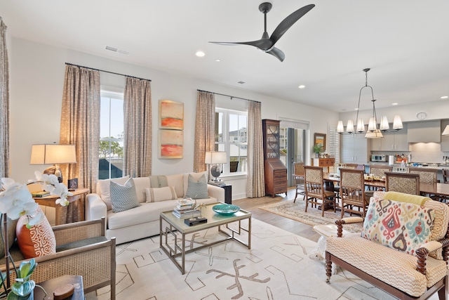 living room featuring ceiling fan and light hardwood / wood-style flooring