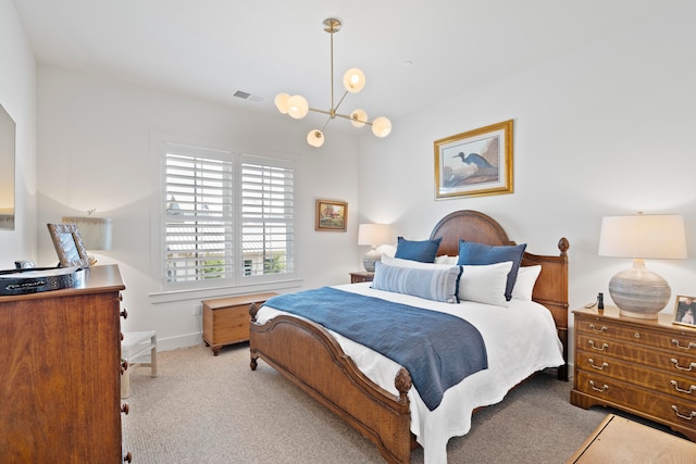 carpeted bedroom with a chandelier