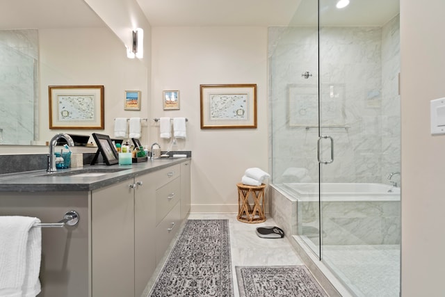 bathroom featuring vanity and independent shower and bath