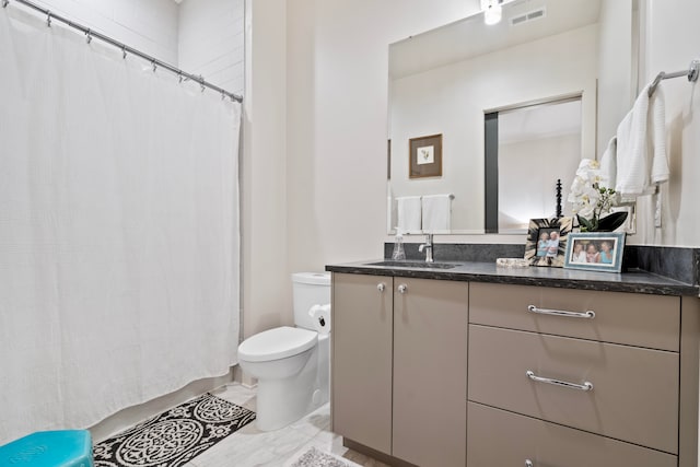 bathroom featuring curtained shower, toilet, and vanity