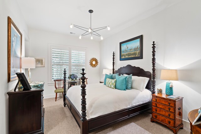 carpeted bedroom featuring an inviting chandelier