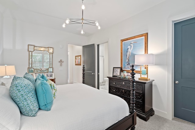 bedroom with light colored carpet, a chandelier, and ensuite bath