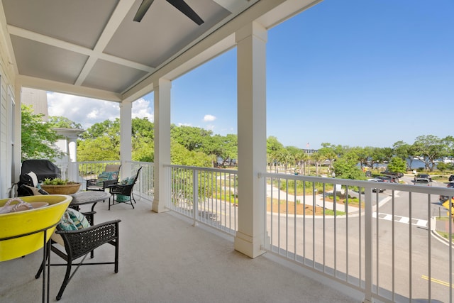 sunroom / solarium with coffered ceiling and ceiling fan