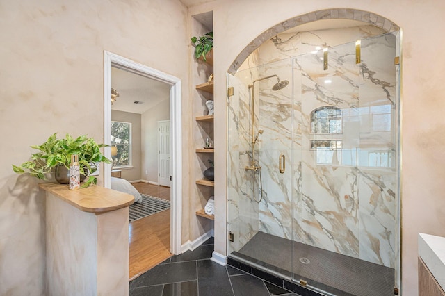 bathroom featuring tile patterned flooring, lofted ceiling, and walk in shower