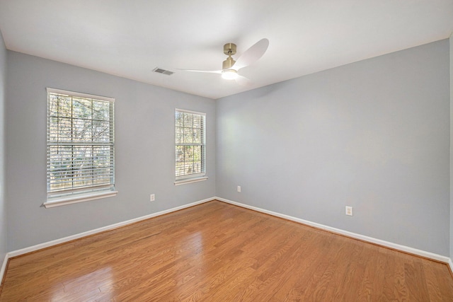 spare room featuring hardwood / wood-style floors and ceiling fan