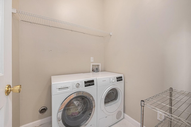 laundry area featuring washing machine and clothes dryer