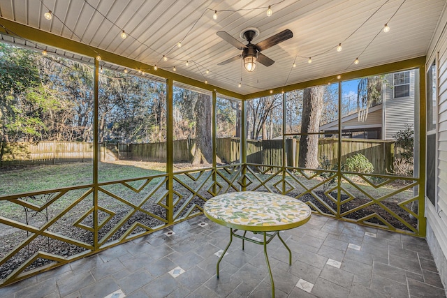 unfurnished sunroom featuring wooden ceiling and ceiling fan