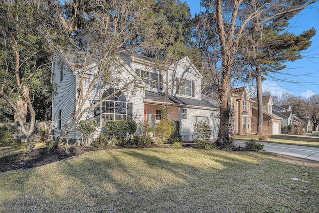 front of property with a garage and a front lawn