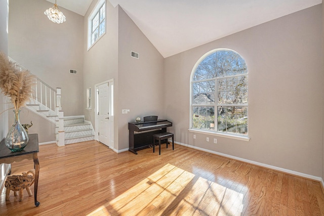 entrance foyer with light hardwood / wood-style flooring, a chandelier, and a healthy amount of sunlight