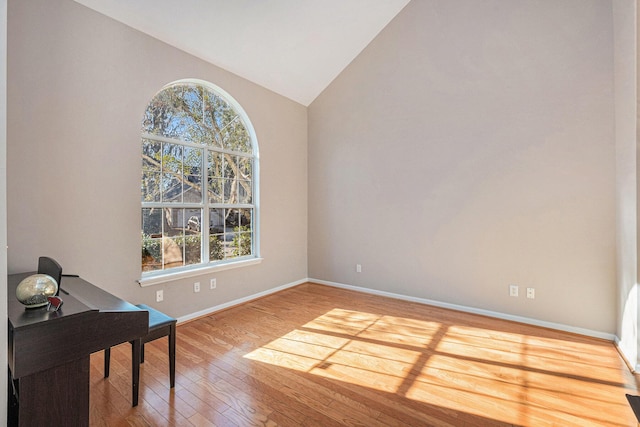 home office featuring hardwood / wood-style flooring and vaulted ceiling