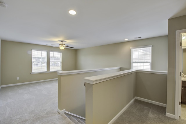 corridor with light colored carpet