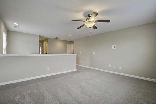 carpeted spare room with ceiling fan