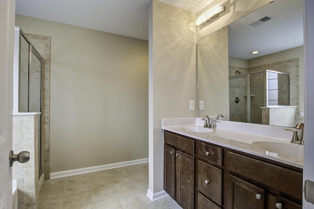 bathroom featuring vanity, tile patterned flooring, and a shower with shower door