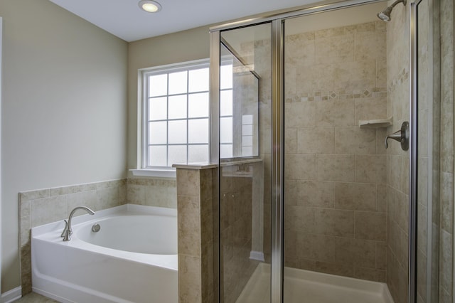 bathroom with independent shower and bath and a wealth of natural light