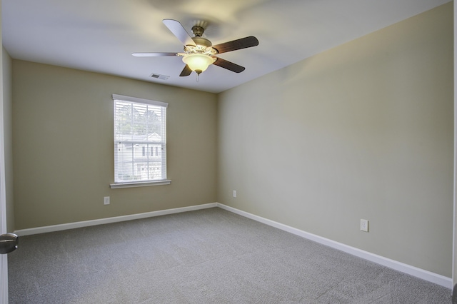 carpeted spare room featuring ceiling fan