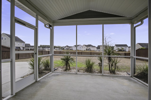 unfurnished sunroom with lofted ceiling and a wealth of natural light