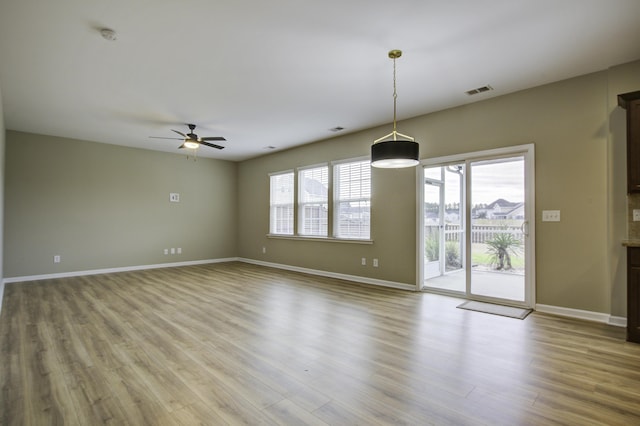 empty room with ceiling fan and light wood-type flooring