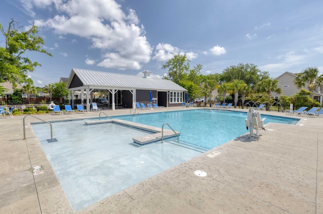 community pool featuring fence and a patio