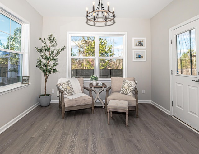 sitting room featuring baseboards, dark wood-style flooring, and a chandelier