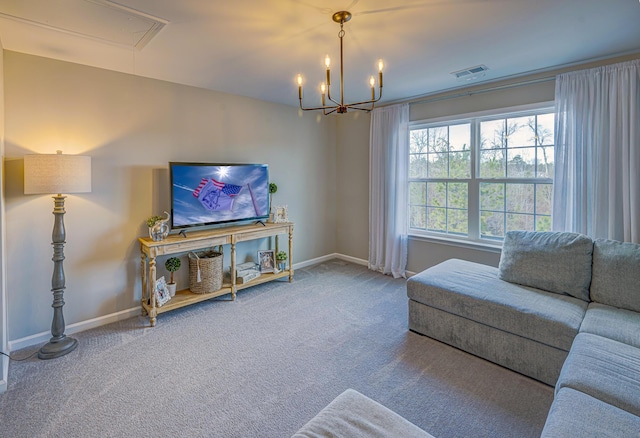 carpeted living area featuring attic access, a notable chandelier, baseboards, and visible vents