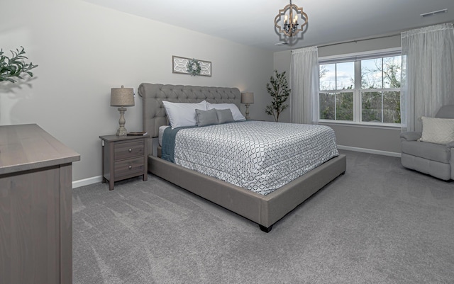 carpeted bedroom with visible vents, an inviting chandelier, and baseboards