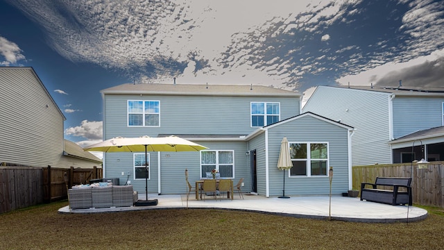 rear view of house featuring a patio area, a fenced backyard, an outdoor living space, and a yard