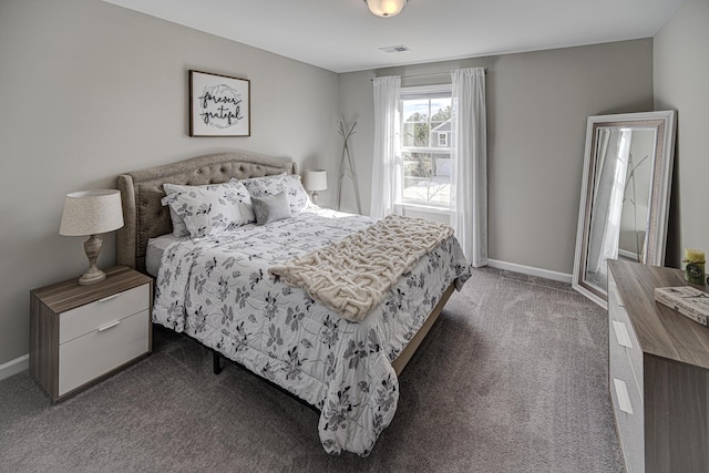 carpeted bedroom with visible vents and baseboards