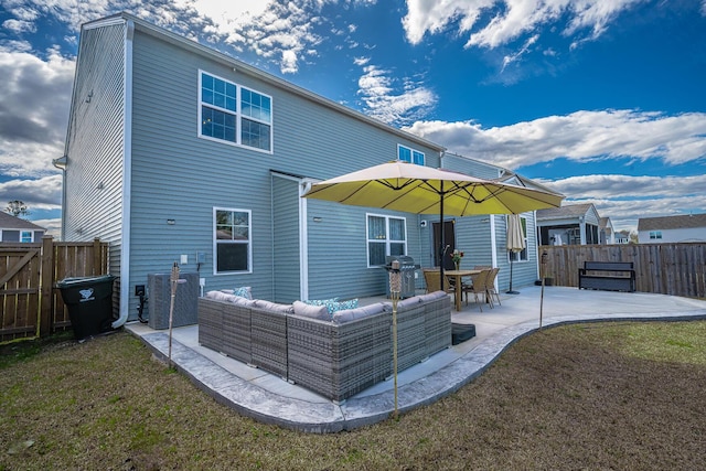 rear view of house featuring a patio, an outdoor living space, a fenced backyard, central air condition unit, and a lawn