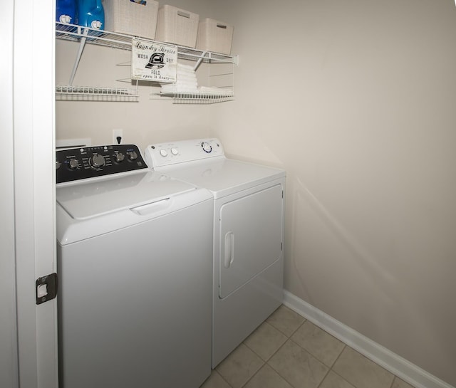 laundry room with light tile patterned floors, laundry area, independent washer and dryer, and baseboards