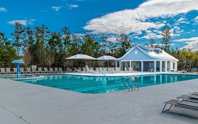 community pool with a patio and fence