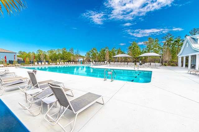 pool featuring a patio and fence