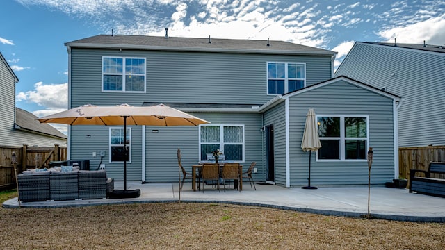 rear view of property with a patio area, outdoor lounge area, a yard, and fence