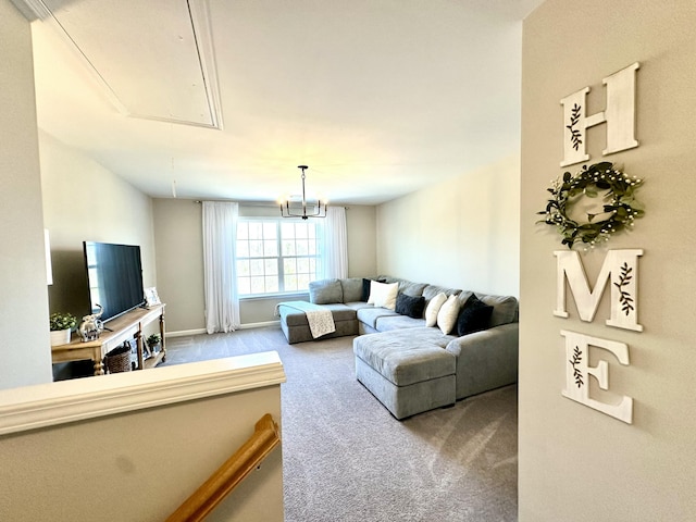 carpeted living area featuring baseboards and attic access