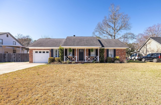 ranch-style house with a garage, a front yard, and covered porch