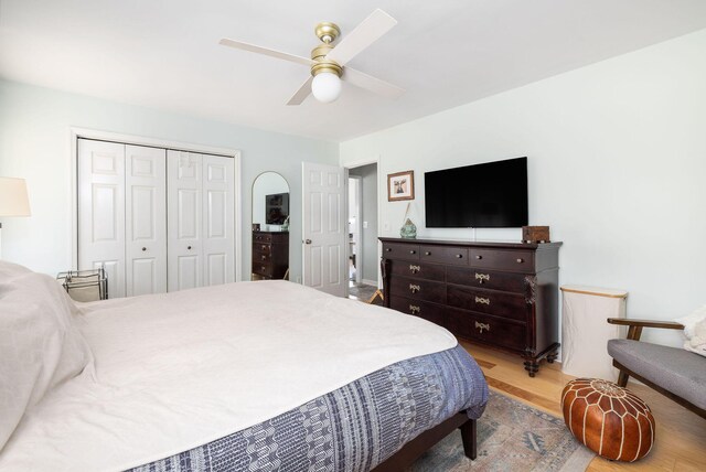 bedroom featuring ceiling fan, a closet, and light wood-type flooring