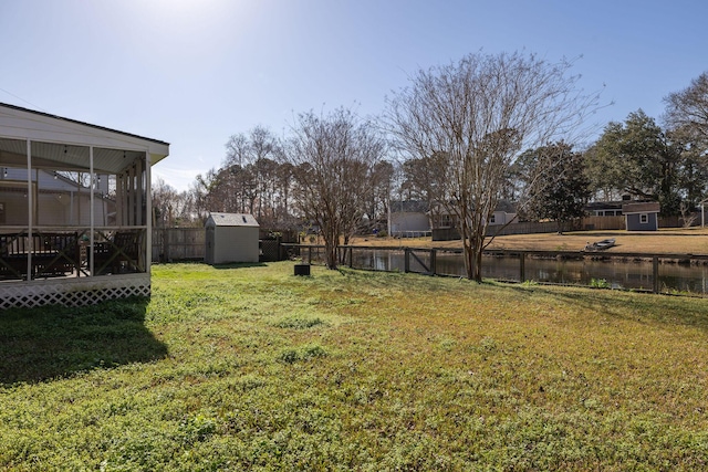 view of yard with a water view and a storage unit