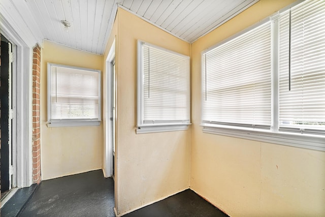 unfurnished sunroom with wood ceiling