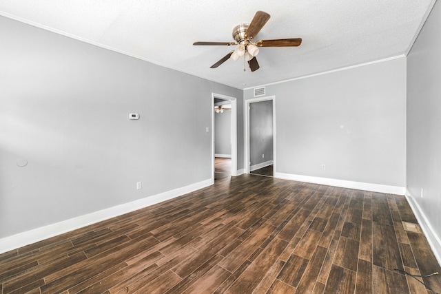 empty room with ceiling fan, dark hardwood / wood-style flooring, crown molding, and a textured ceiling