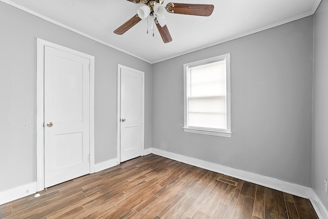 unfurnished bedroom featuring ceiling fan, crown molding, and hardwood / wood-style flooring