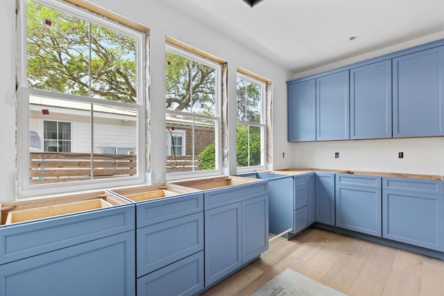 931 Kincade Dr, Mount Pleasant, SC 29464 - kitchen with light wood-type flooring, blue cabinets, and light countertops