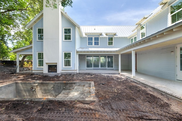 931 Kincade Dr, Mount Pleasant, SC 29464 - rear view of property featuring metal roof and a chimney