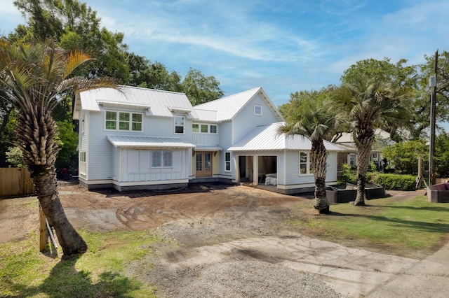 931 Kincade Dr, Mount Pleasant, SC 29464 - view of front of property with metal roof, board and batten siding, driveway, and a front lawn