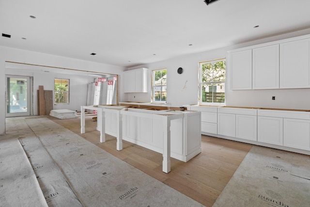 931 Kincade Dr, Mount Pleasant, SC 29464 - kitchen featuring light wood-style flooring, healthy amount of natural light, white cabinetry, and a center island