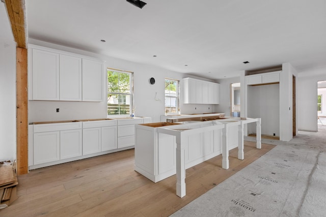 931 Kincade Dr, Mount Pleasant, SC 29464 - kitchen featuring white cabinetry, a kitchen island, and light wood-style flooring